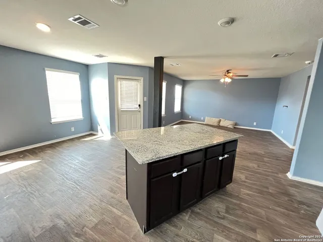 a kitchen with a stove and a wooden floor