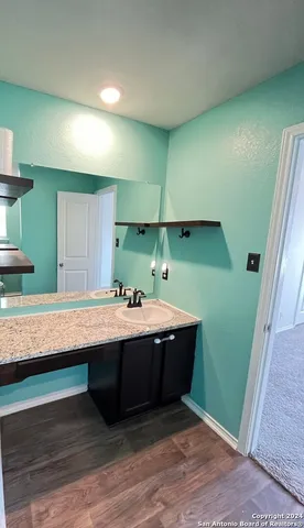 a view of kitchen with sink wooden floor and window