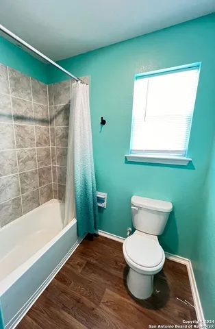 a bathroom with a toilet and a bathtub