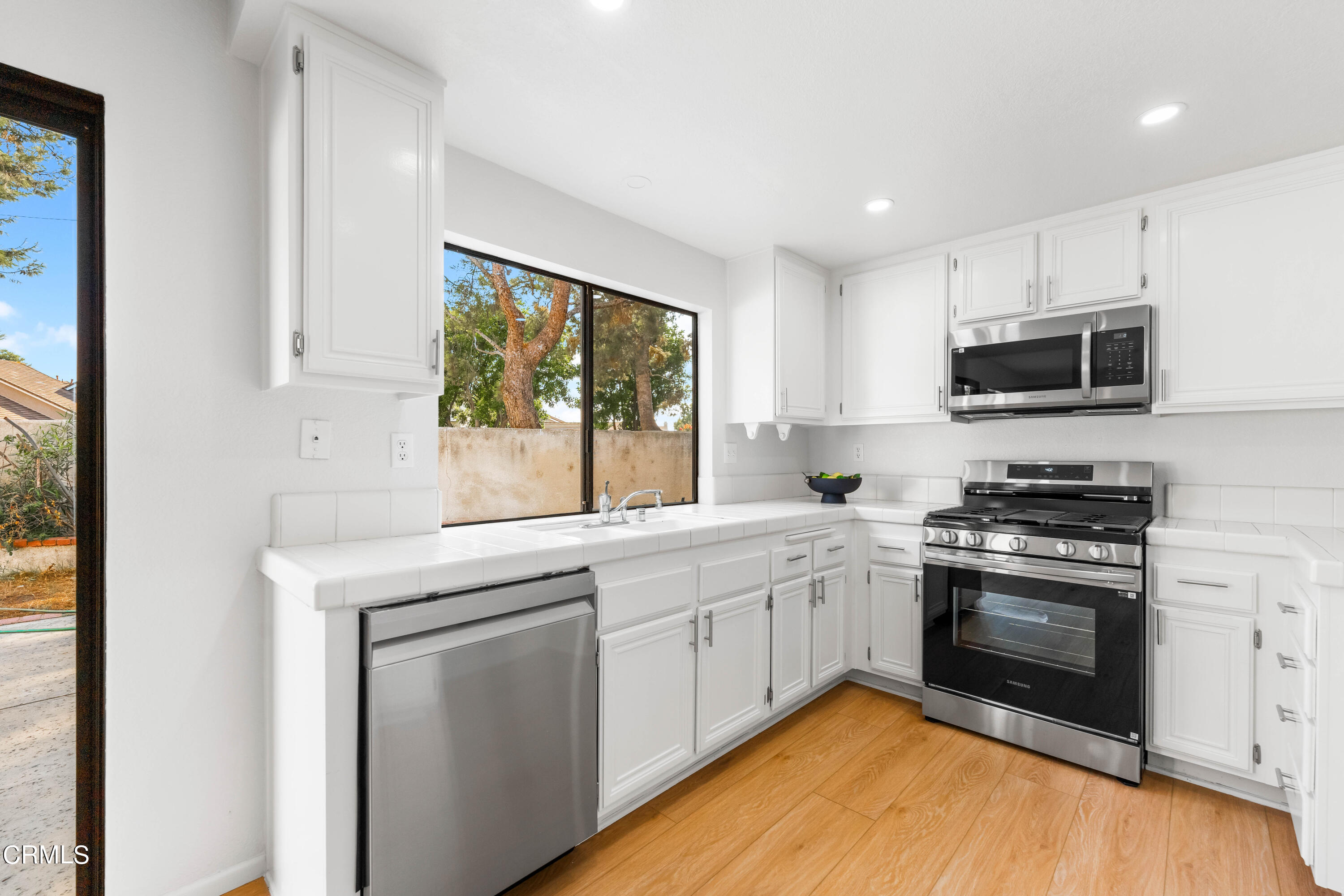 24 Silkberry Irvine, CA 92614 - Photo 11 of 33 a kitchen with stainless steel appliances granite countertop a stove and a sink