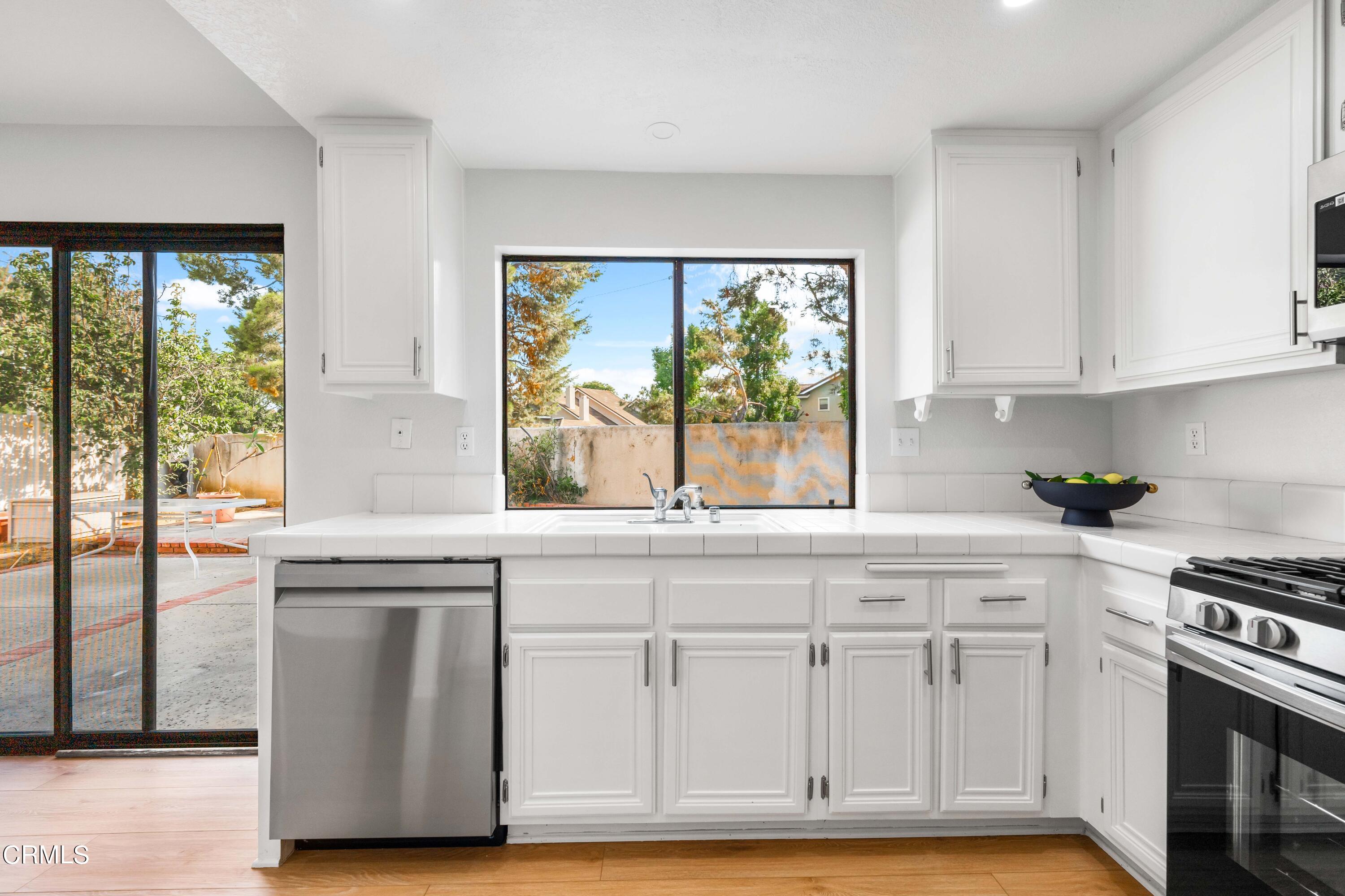 24 Silkberry Irvine, CA 92614 - Photo 13 of 33 a kitchen with granite countertop white cabinets and a window
