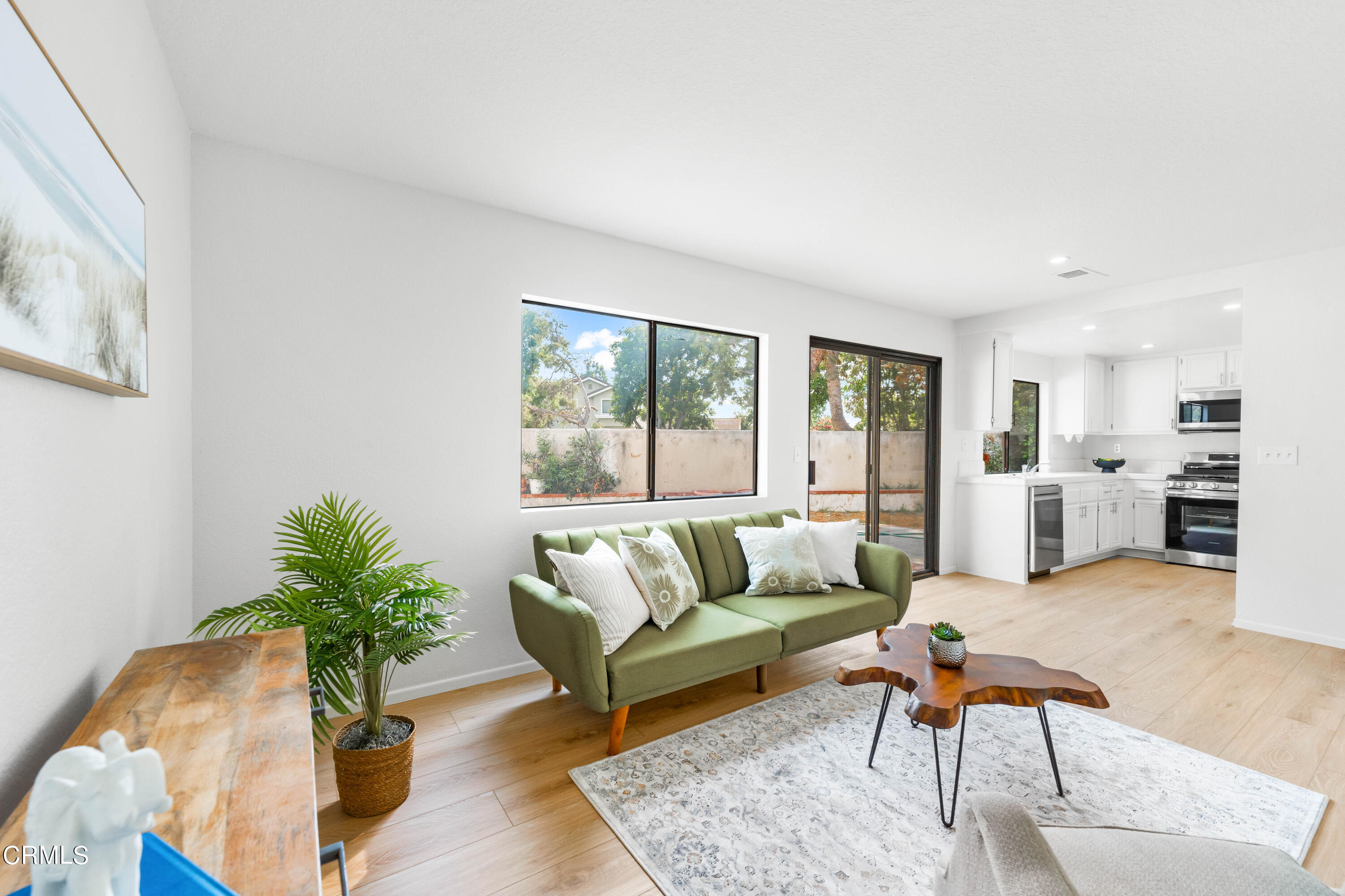 24 Silkberry Irvine, CA 92614 - Photo 9 of 33 a living room with furniture potted plant and kitchen view
