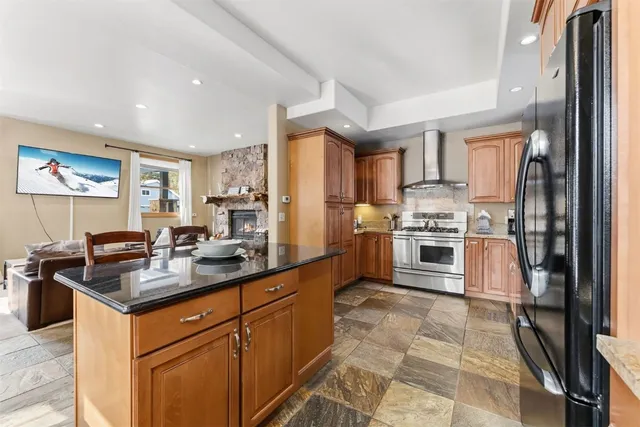 a kitchen with stainless steel appliances granite countertop a stove sink and cabinets