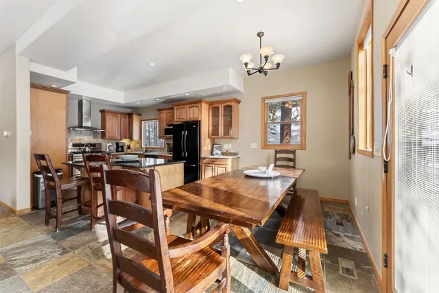 a view of a dining room with furniture and a chandelier