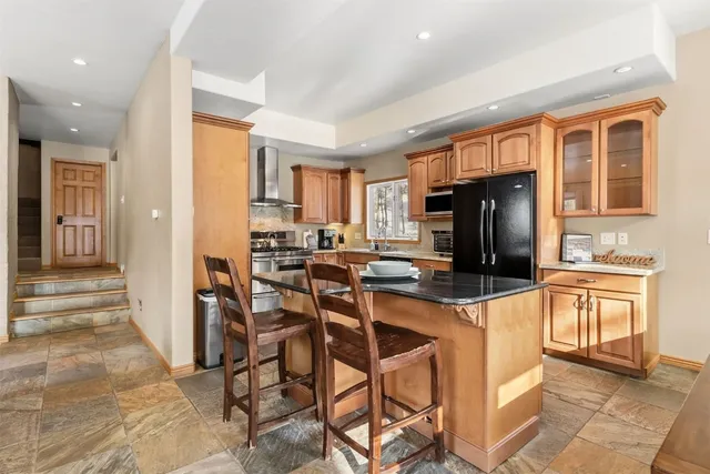 a kitchen with stainless steel appliances a stove a refrigerator and a stove top oven