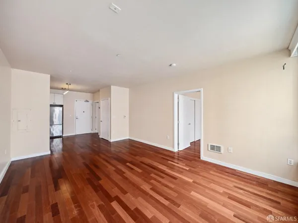 a view of an empty room and wooden floor