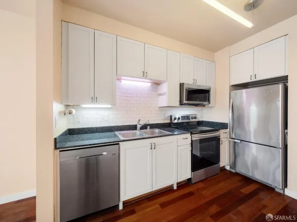 a kitchen with a sink stove and refrigerator