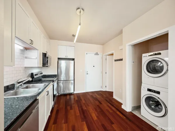 a kitchen with a sink a stove and cabinets