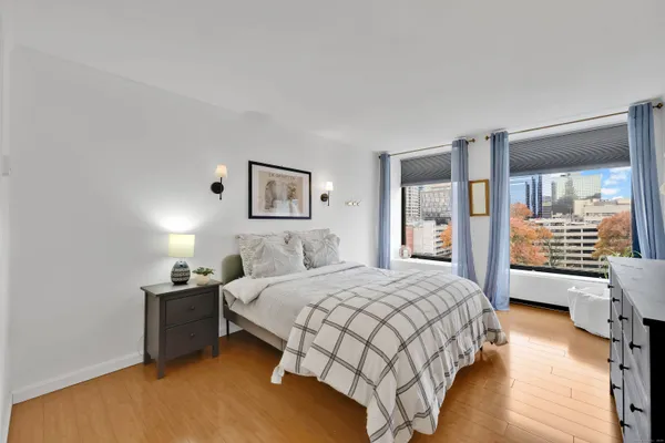 a bedroom with a bed and wooden floor