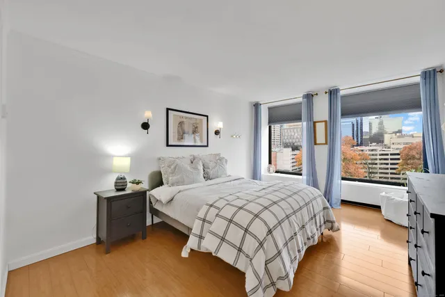 a bedroom with a bed and wooden floor