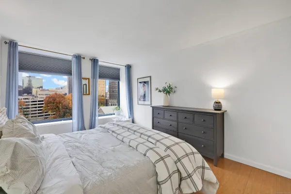 a bedroom with a bed and a large window