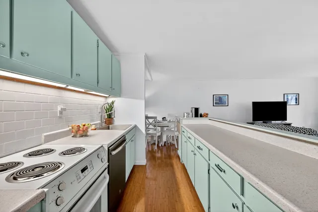 a kitchen with a stove and a refrigerator