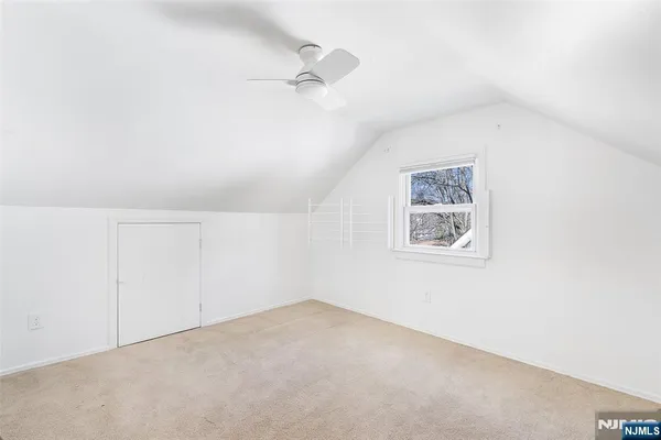 an empty room with a ceiling fan