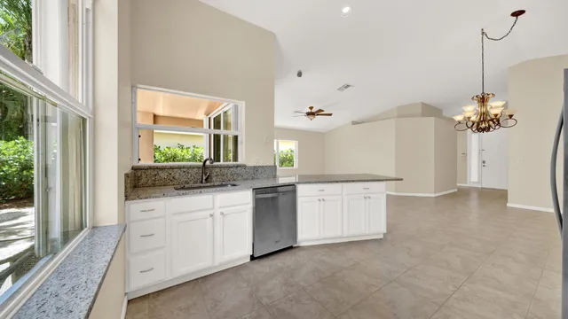 a view of a livingroom with a window and a ceiling fan