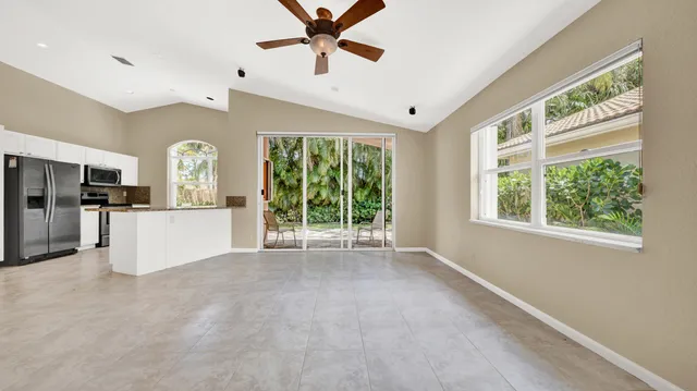 a front view of a house with a yard and potted plants