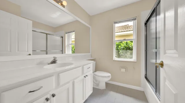 a front view of a house with a garden and plants