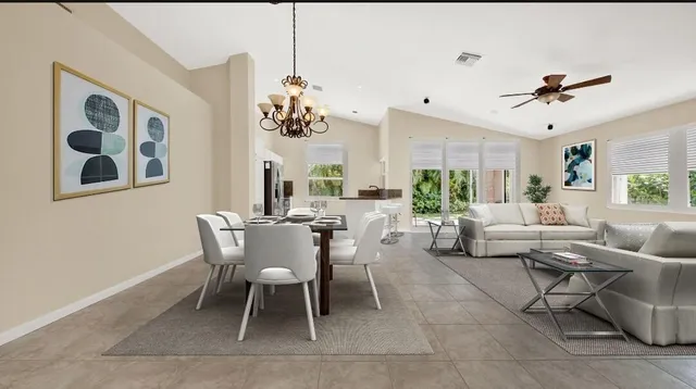 a kitchen with granite countertop a refrigerator and a stove top oven