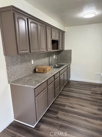a kitchen with stainless steel appliances granite countertop a sink and a stove