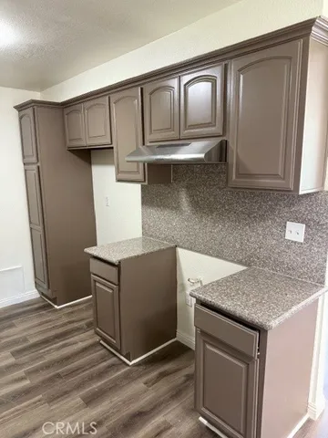 a kitchen with granite countertop a stove and a sink