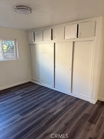 a view of a refrigerator in kitchen and wooden floor