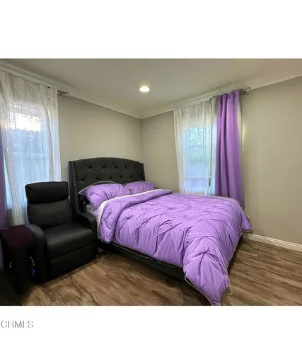 a bedroom with a bed and a couch