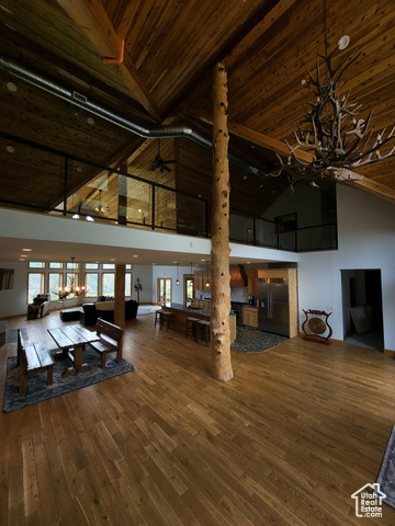 1406 South Bartholomew Cyn Road Springville, UT 84663 - Photo 5 of 19 Living area with high vaulted ceiling, a wooden ceiling with exposed beams, hardwood / wood-style flooring, and a chandelier