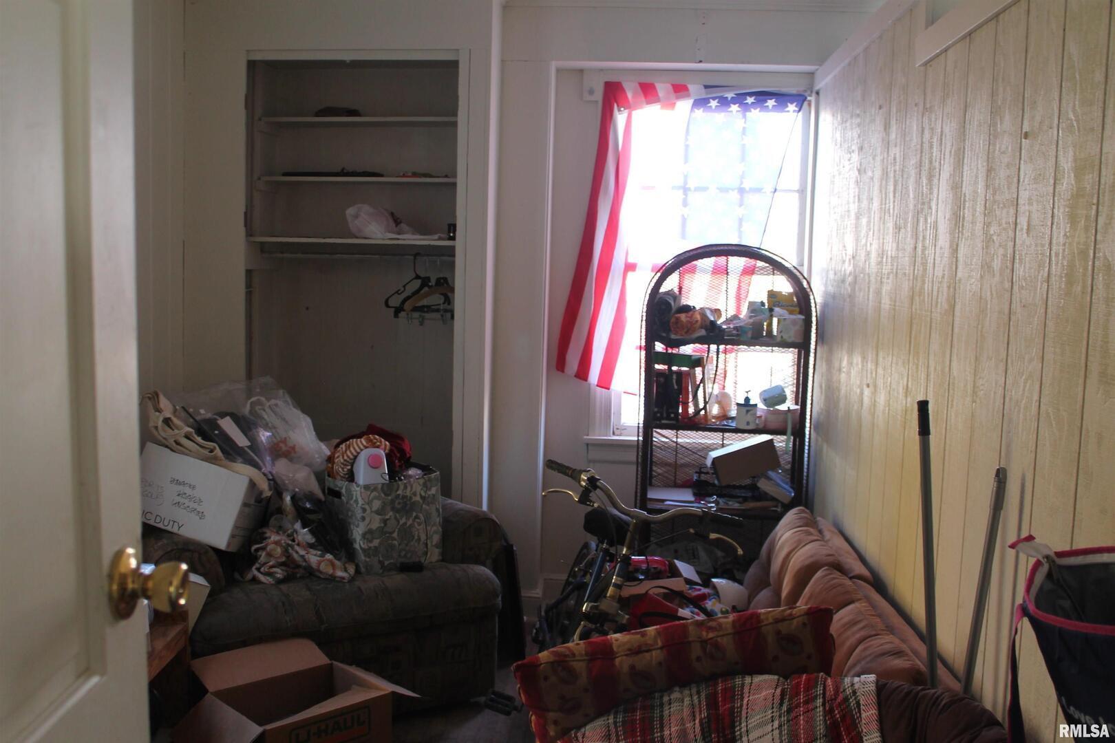 502 West Freeman Street, Unit 1 Carbondale, IL 62901 - Photo 8 of 17 a room with a door wooden floor and windows