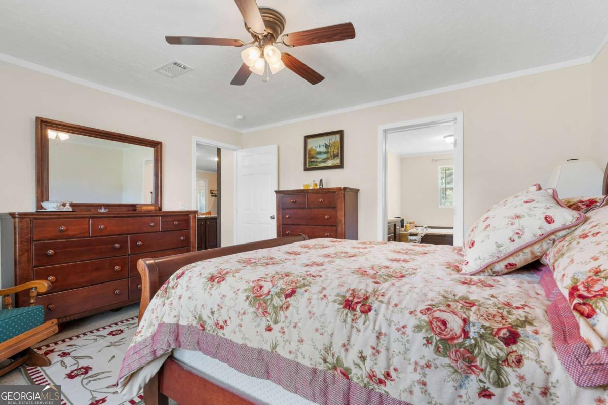 3516 Bennetts Landing Road Millen, GA 30442 - Photo 16 of 34 a bedroom with a bed and wooden floor