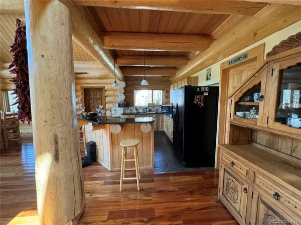 a kitchen with stainless steel appliances kitchen island granite countertop a refrigerator and a stove