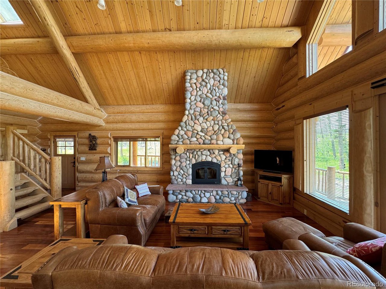 2255 Port Loop Fort Garland, CO 81133 - Photo 21 of 42 a living room with furniture a fireplace and a ceiling fan