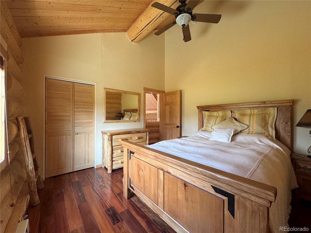 2255 Port Loop Fort Garland, CO 81133 - Photo 23 of 42 a bedroom with a bed and a flat tv screen on the dresser