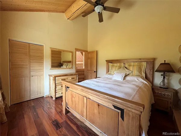 a bedroom with a bed and a tv on the wall