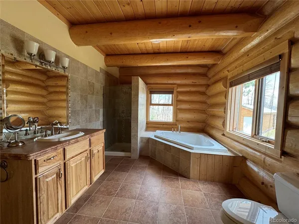 a bathroom with a granite countertop sink a toilet and bathtub
