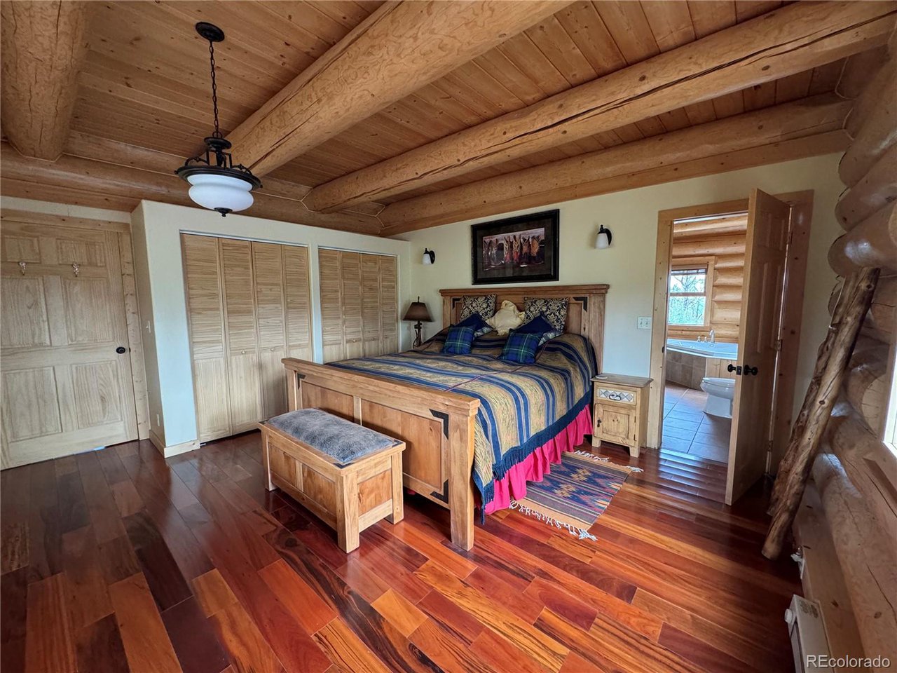 2255 Port Loop Fort Garland, CO 81133 - Photo 9 of 42 a bedroom with a bed wooden floor and window