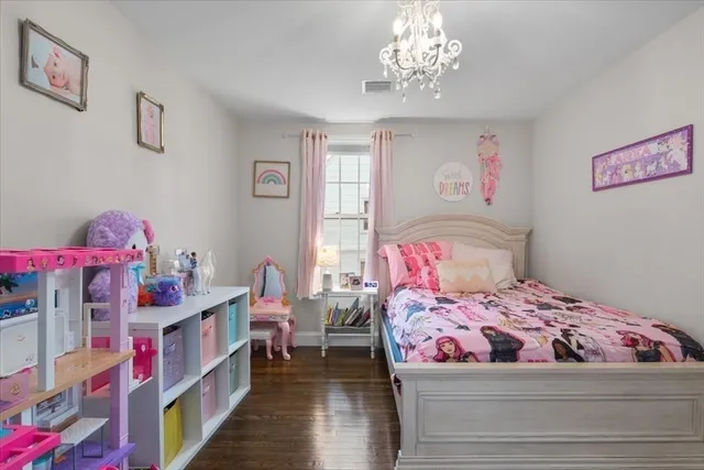 a bedroom with a bed and a chandelier