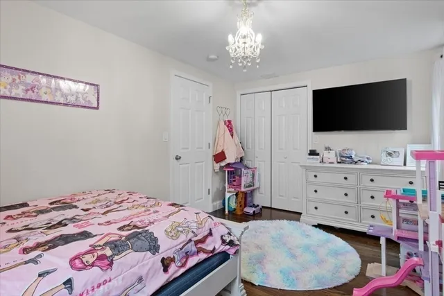 a bedroom with a bed and flat screen tv