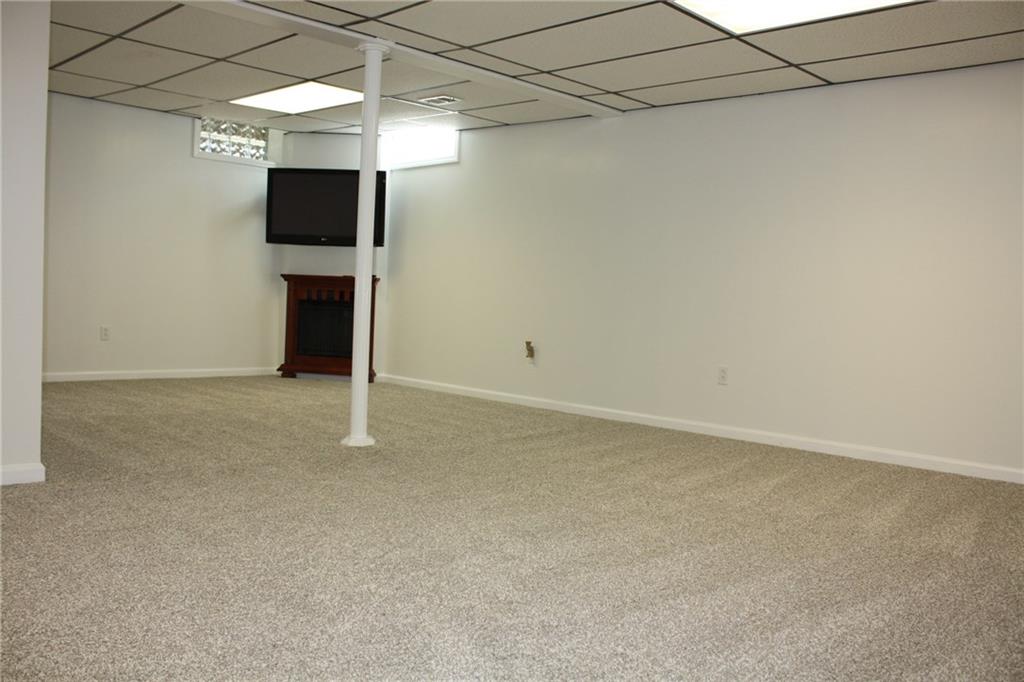 81 Bellview Circle McKees Rocks, PA 15136 - Photo 19 of 24 WOW! What a Gameroom. Brand new! Never used by current owner. Features brand new carpet, electric fireplace, & TV. Glass block windows.