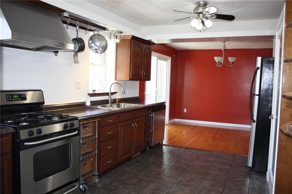 81 Bellview Circle McKees Rocks, PA 15136 - Photo 5 of 24 Kitchen featuring stainless steel appliances including gas stove with commercial style hood. Notice the pot rack, and pull-out cart.