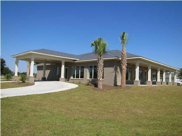 32-167 Riverview Road Navarre, FL 32566 - Photo 3 of 11 a front view of a house with garden