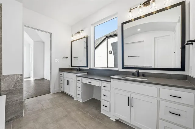 a bathroom with a granite countertop sink double and mirror
