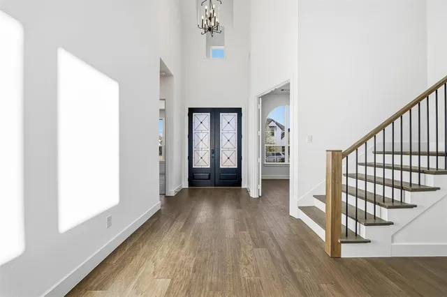 a view of a hallway view with wooden floor and staircase