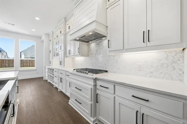 a kitchen with granite countertop a stove and a sink