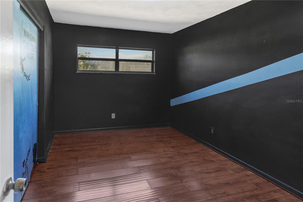 310 Kenmore Road Brandon, FL 33511 - Photo 16 of 33 a view of an empty room with wooden floor and a window