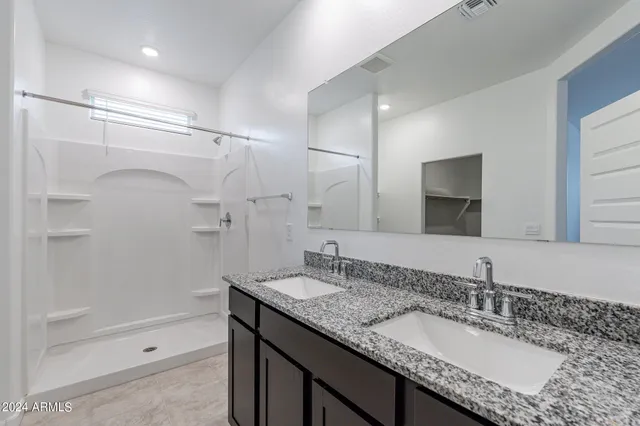 a bathroom with a glass shower door