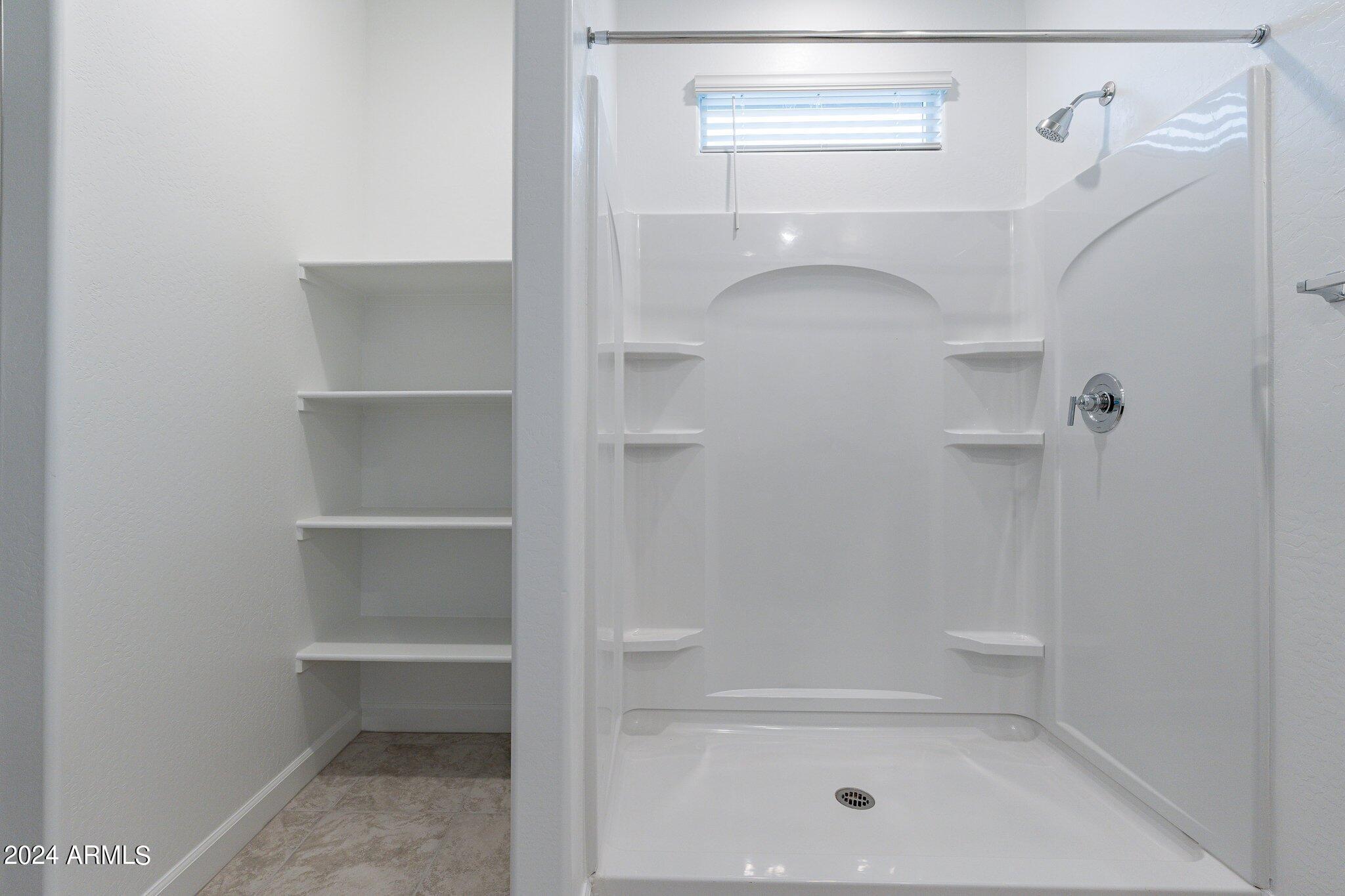 5447 Azara Drive San Tan Valley, AZ 85140 - Photo 13 of 21 a bathroom with a glass shower door
