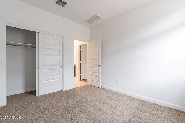 an empty room with closet area