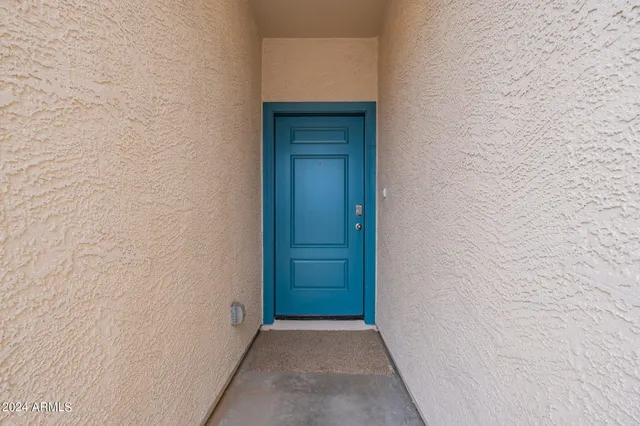 a view of a hallway with closet and bathroom