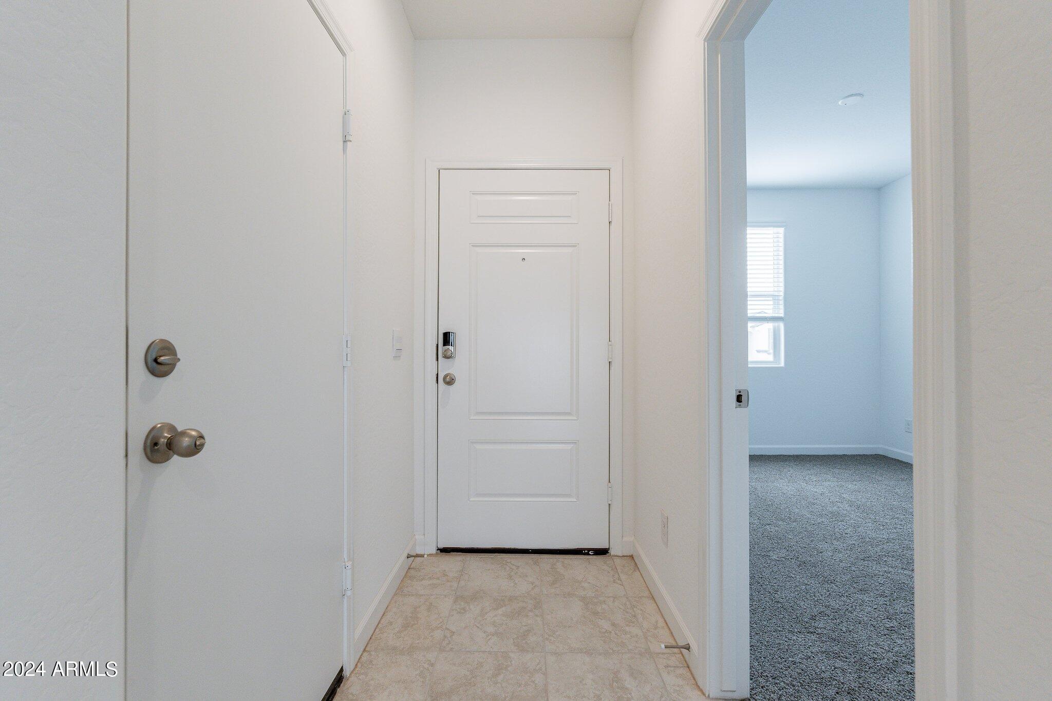 5447 Azara Drive San Tan Valley, AZ 85140 - Photo 3 of 21 a view of a hallway with closet and bathroom