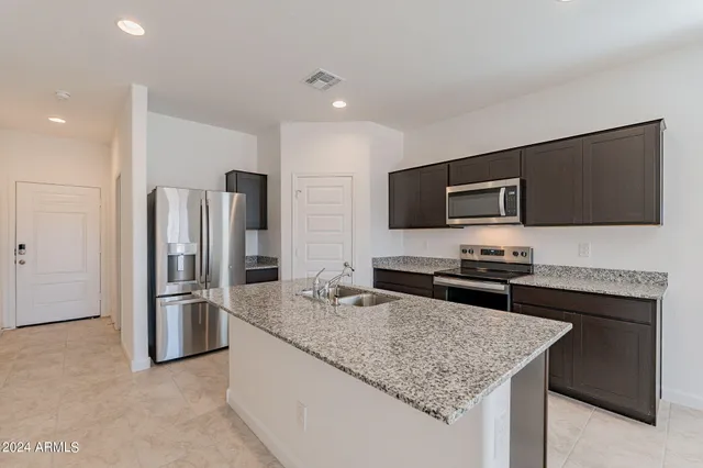 a kitchen with a sink a counter space and cabinets