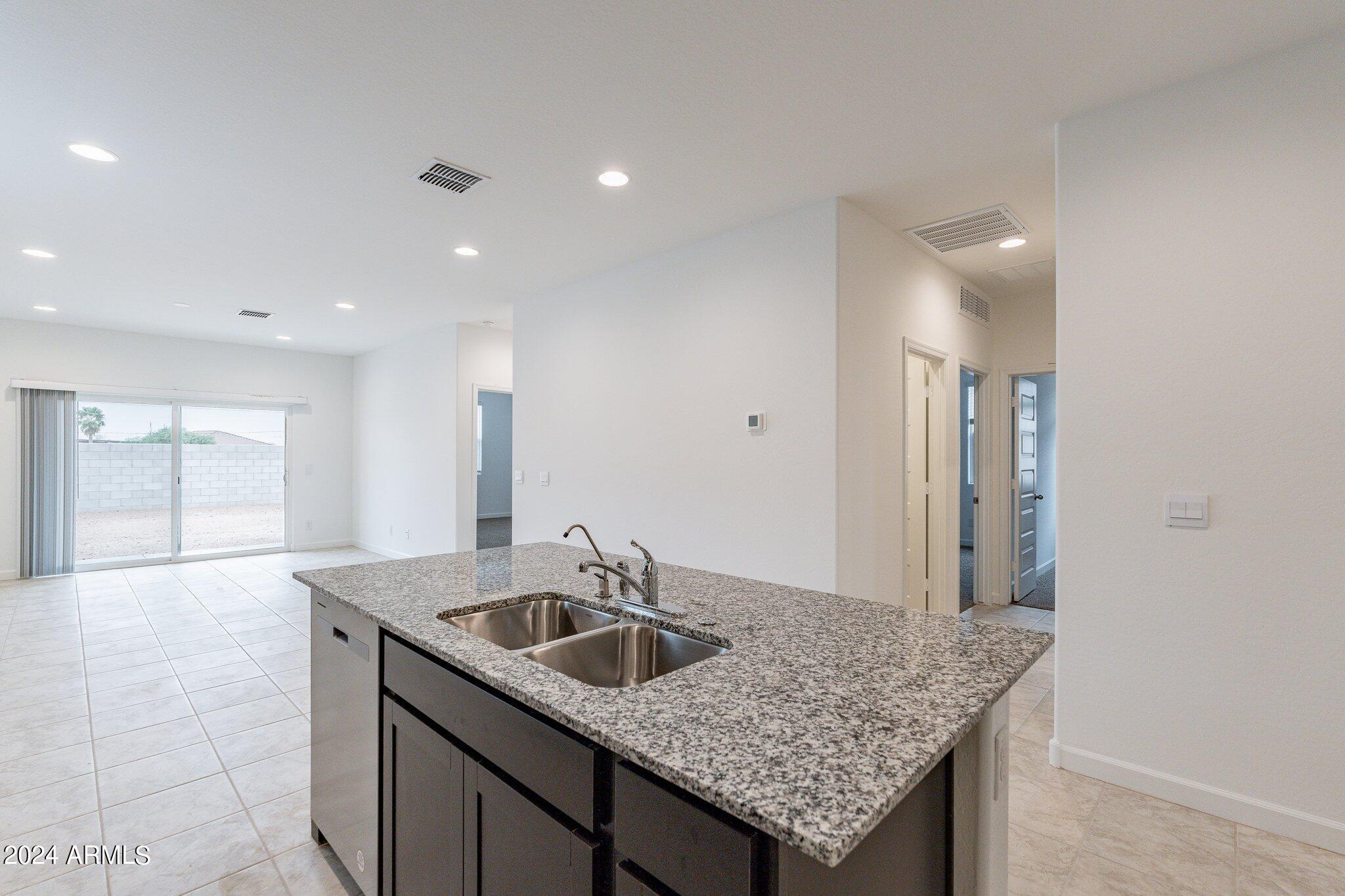 5447 Azara Drive San Tan Valley, AZ 85140 - Photo 7 of 21 a kitchen with a sink a counter space and cabinets